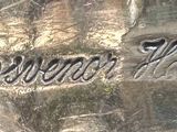 a close up of a silver plate with the words gravy house on it