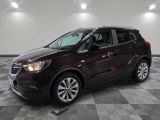 the buick suv is parked in a large room with a checkered floor