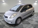 a picture of a small silver car parked in a garage