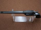 a gun that is sitting on top of a clear holder
