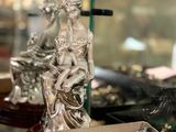 a display case with a statue of a woman and a box of ornaments