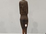 two wooden statues that are sitting on a table