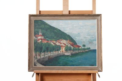 painting on easel of a painting of a village by the water