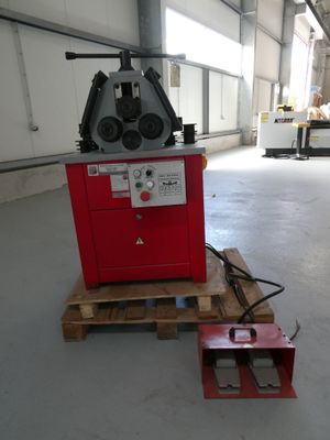 a red machine that is sitting on a pallet in a warehouse