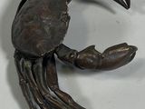a metal crab that is sitting on a table
