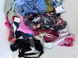 a pile of underwear on the floor next to a pair of shoes