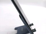 a cell phone sitting on a stand on a table