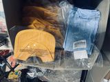 a cardboard box filled with clothes and other items