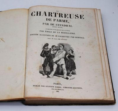 un livre ouvert sur lequel figure l'image d'un homme tenant un bébé dans ses bras