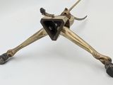 a metal object that is sitting on a white surface