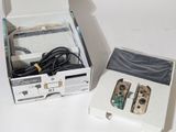 two nintendo wii controllers in a box on a table