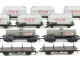 a lot of train cars that are lined up on the tracks