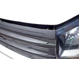 a close up of a car ' s headlight and front bumper