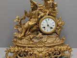 a gold clock sitting on top of a table