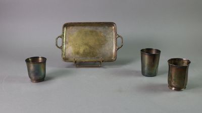 four cups and a tray sitting on a table