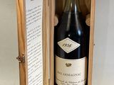 a bottle of wine in a wooden box on a table