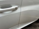 a close up of a door handle on a white car
