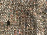 a close up of a sweater with holes in it