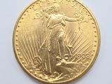 a close up of a gold coin on a white surface