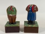 two wooden figurines of a man and a woman