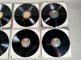 four black vinyl records sitting on top of each other on a table