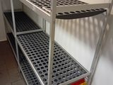a metal shelf that has a bunch of folders on top of it