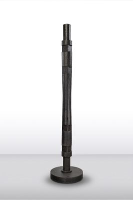 an image of a metal pole with a black handle on a white surface