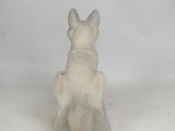 statue of a dog sitting on a block on a white background
