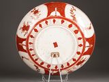 an orange and white plate with a red and white design on it
