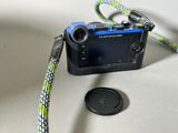 a small camera with a lanyard attached to it