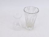 a glass vase and a glass vase on a white surface