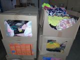 two boxes that have clothes in them on top of each other