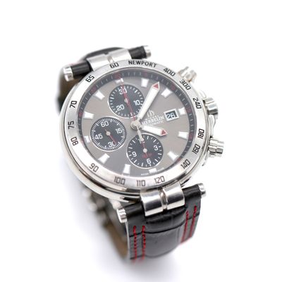 a close up of a watch on a white surface