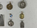 many different types of religious charms displayed on a table