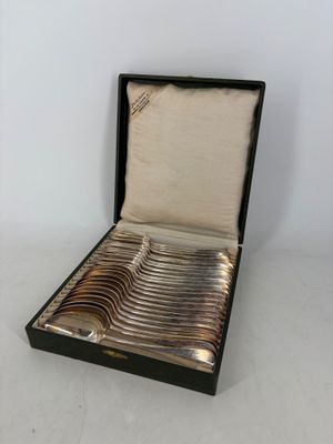 silverware in a black case on a white surface