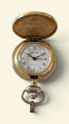 a gold pocket watch with a key hanging from it ' s side