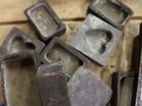 several pieces of metal sitting on top of a table next to each other