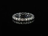 a close up of a silver ring on a black surface