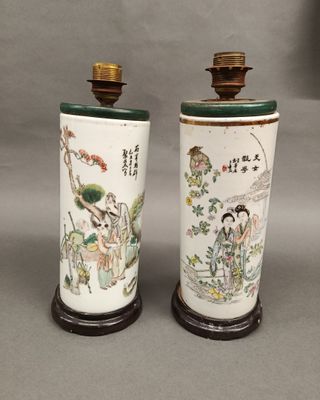 pair of asian vases with asian characters on them on a table