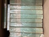 a lot of books in a box that are wrapped in plastic