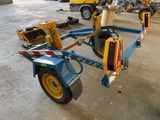 a blue trailer with yellow wheels in a warehouse