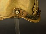 a close up of a gold helmet on a stand