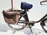 a bicycle that has a bag on the back of it