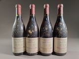 three bottles of red wine are lined up on a table