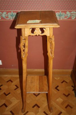 a small wooden table with a book on top of it