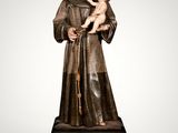 a statue of a man holding a baby in his arms
