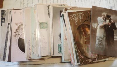 a pile of old postcards sitting on a table