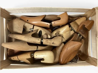 many wooden shoes in a wooden box on the floor