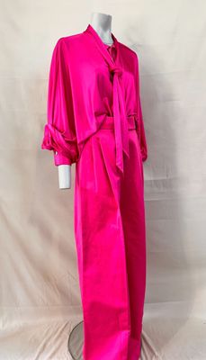 a mannequin wearing a bright pink dress with a tie around the waist