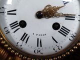 a clock with roman numerals on the face of it